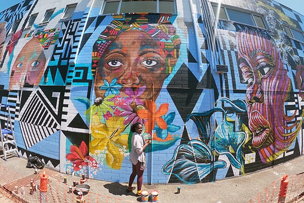 Sanaa arts street artist with artwork, Percy Court, Adelaide